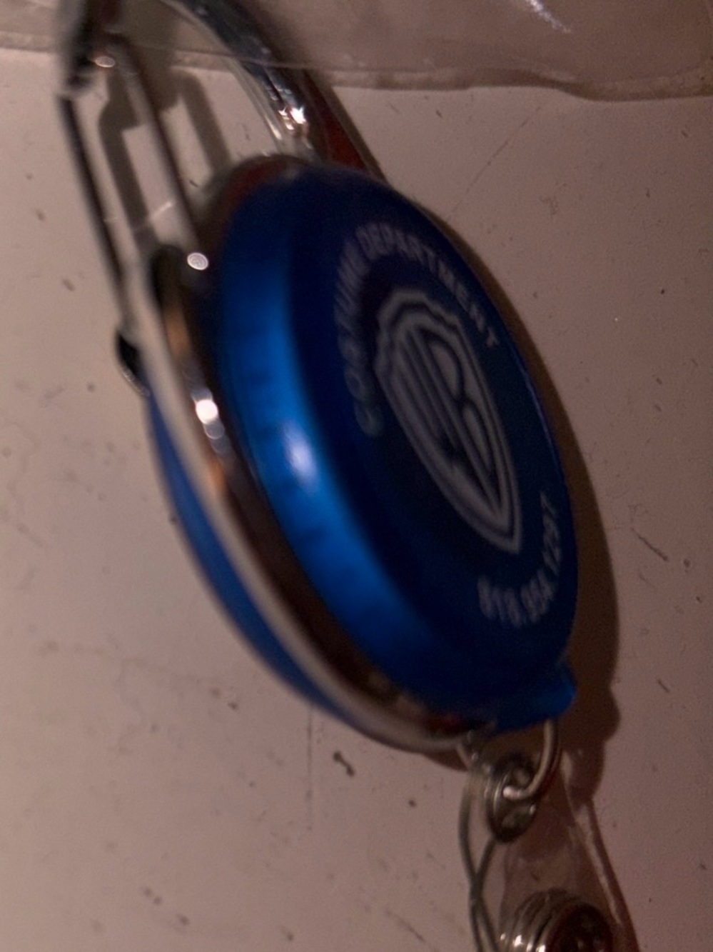 Blue Warner Bros. Logo Retractable Badge Reel and tape measurement